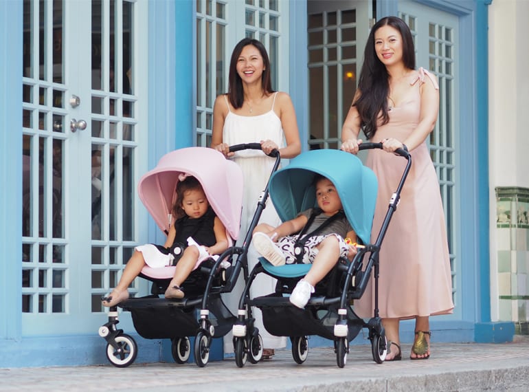 Belinda and Tjin with kids rocking the soft pink and petrol blue Bugaboo Bee 3 strollers - the perfect compact pram for zipping around Singapore with little ones.