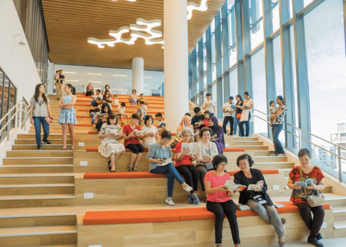 people sitting on the steps at tampines library