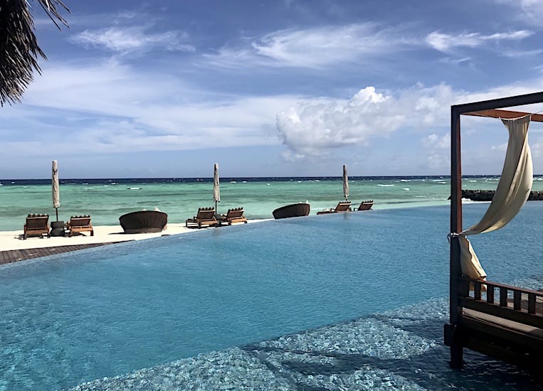 Poolside daybed or lounging on the sand? Tough decisions at The Residence Maldives.