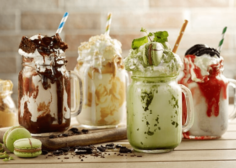 four different milkshakes on the table